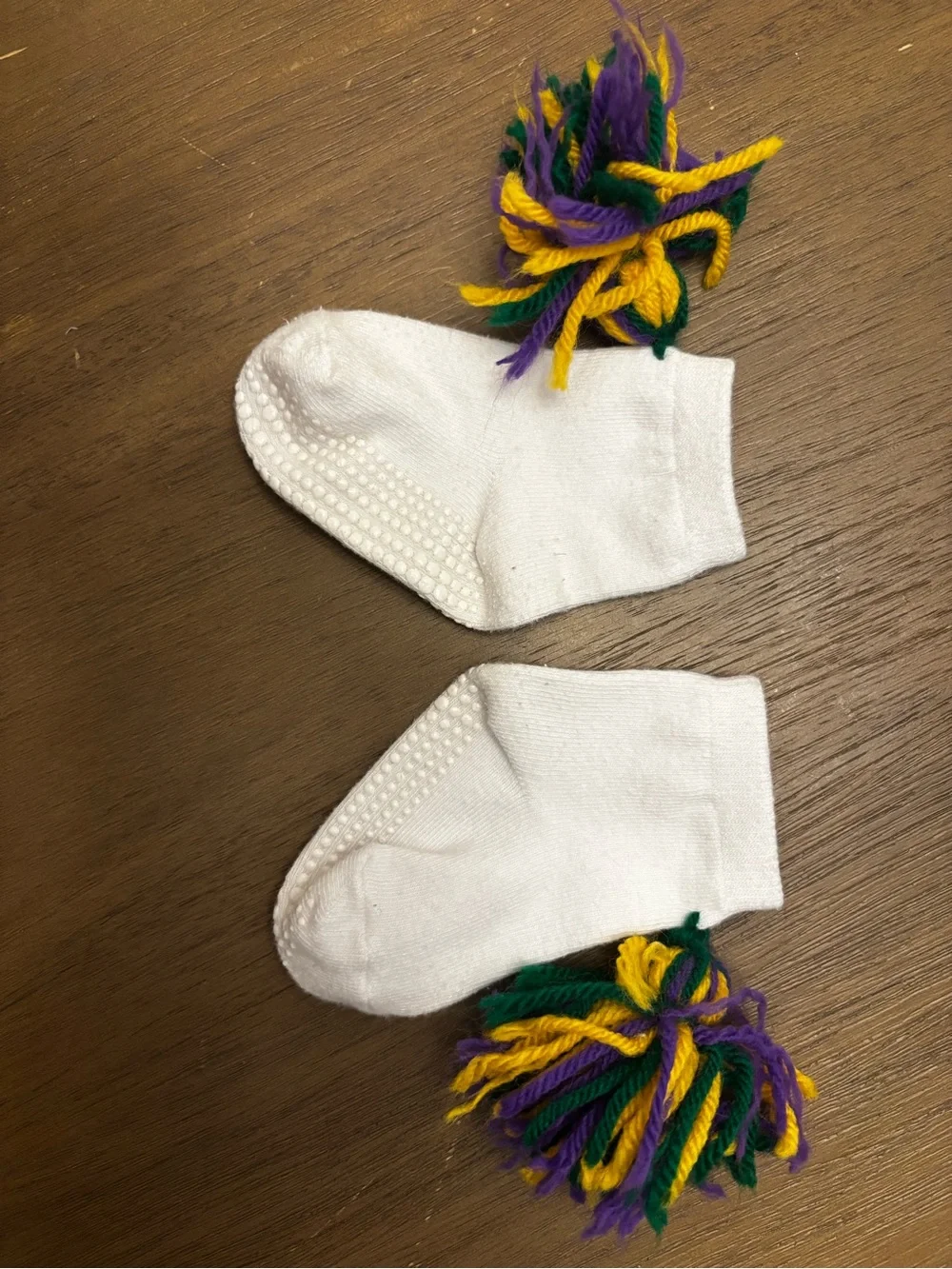 Mardi Gras White Baby Socks with Purple, Green & Yellow Pom Poms